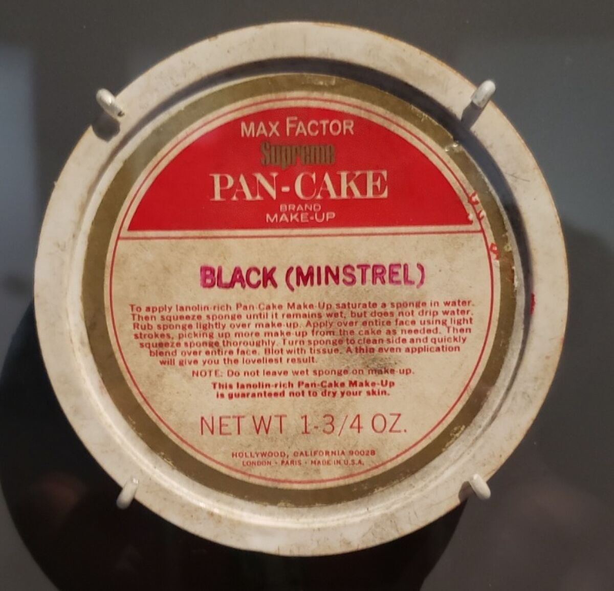 The label on a vintage tin of makeup labels it as "Black (Minstrel)."