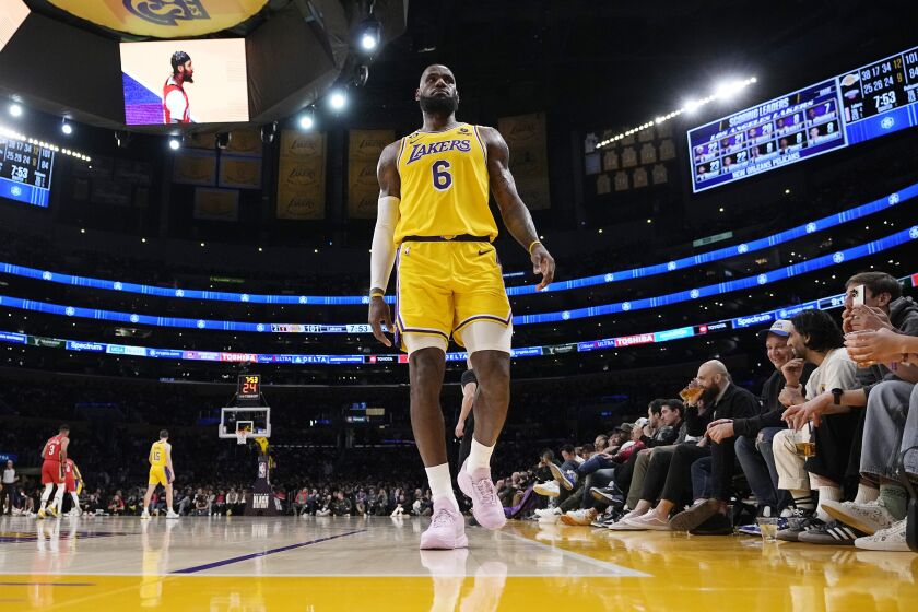 Los Angeles Lakers forward LeBron James walks to the corner of the court during the second half of an NBA basketball game against the New Orleans Pelicans Wednesday, Feb. 15, 2023, in Los Angeles. (AP Photo/Mark J. Terrill)