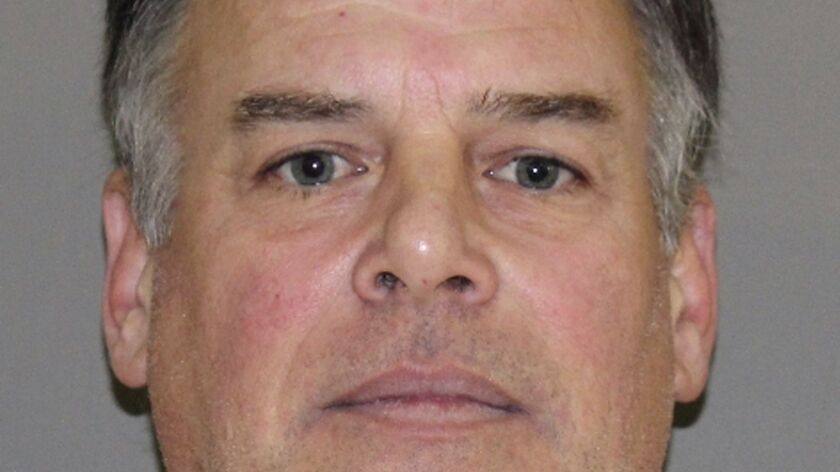 John Wetteland, 52, shown in a booking photo, has been charged with continuous sex abuse of a child under age 14.