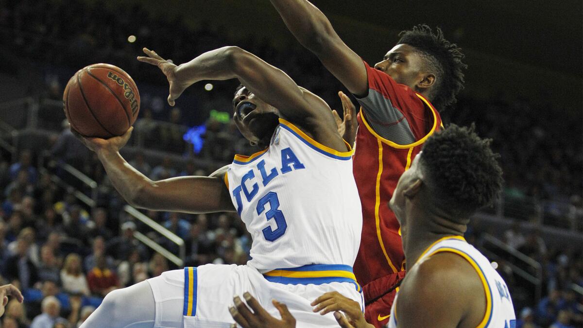 UCLA guard Aaron Holiday (3) scores against USC forward Chimezie Metu (4) during their game Wednesday night at Pauley Pavilion.