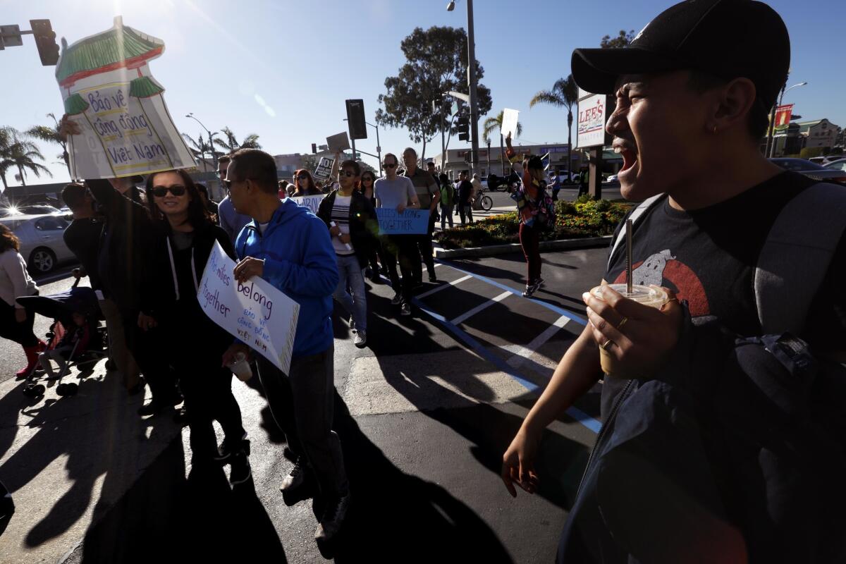 My Nguyen, right, shouts slogans while joining members of the Little Saigon community who march and rally against a Trump Administration's policy shift that puts 8,500 Vietnamese community members at risk of deportation.
