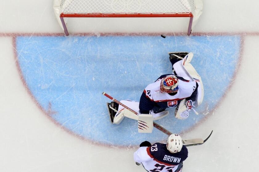 Dustin Brown scores past Slovakia goalie Jaroslav Halak.