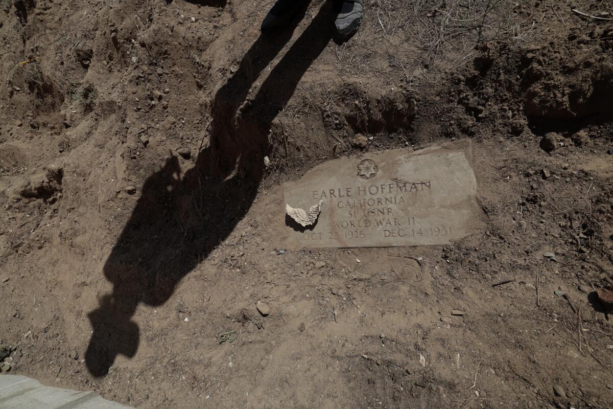 An uncovered headstone of WWII veteran Earle Hoffman in the backyard of a home in Lawndale.
