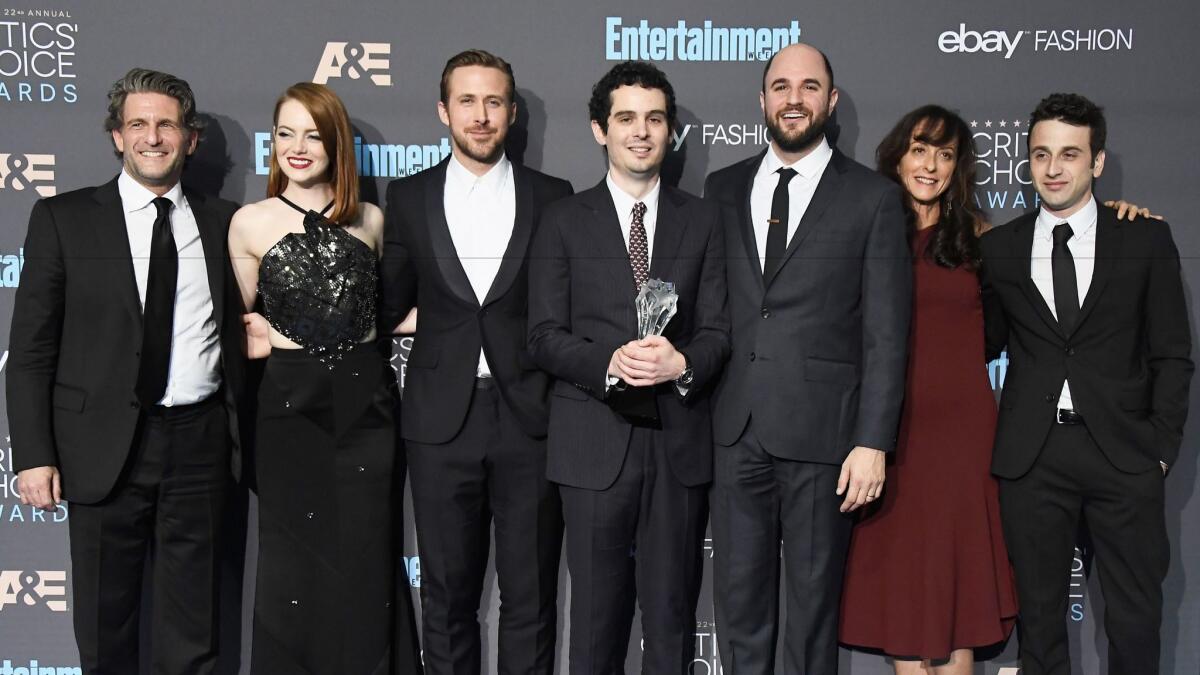 "La La Land" producer Gary Gilbert, left, actors Emma Stone and Ryan Gosling, director Damien Chazelle, producer Jordan Horowitz, costume designer Mary Zophres and composer Justin Hurwitz. Chazelle is holding the best picture Critics' Choice Award.