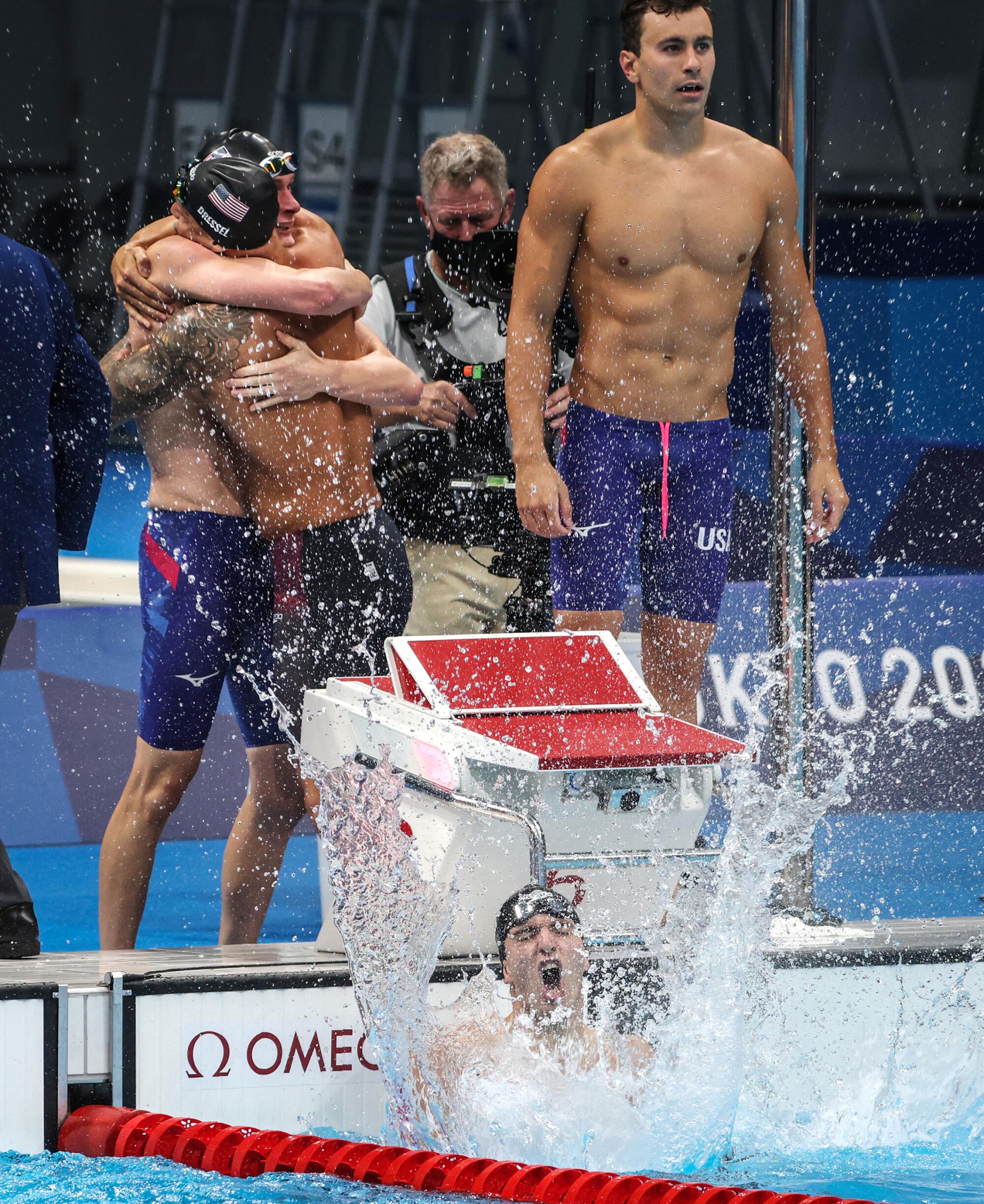 Zach Apple splashes the water in jubilation after winning the men's 4x100 freestyle relay.