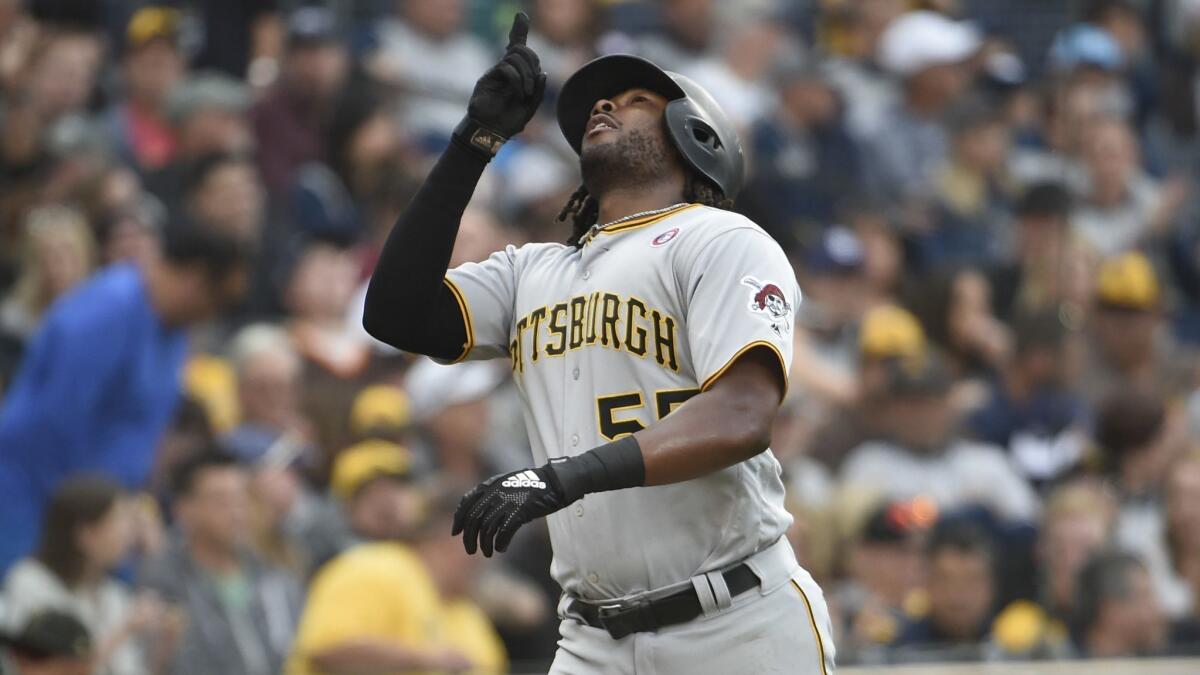 Josh Bell points skyward after hitting a three-run home run during a game against the San Diego Padres on May 18.