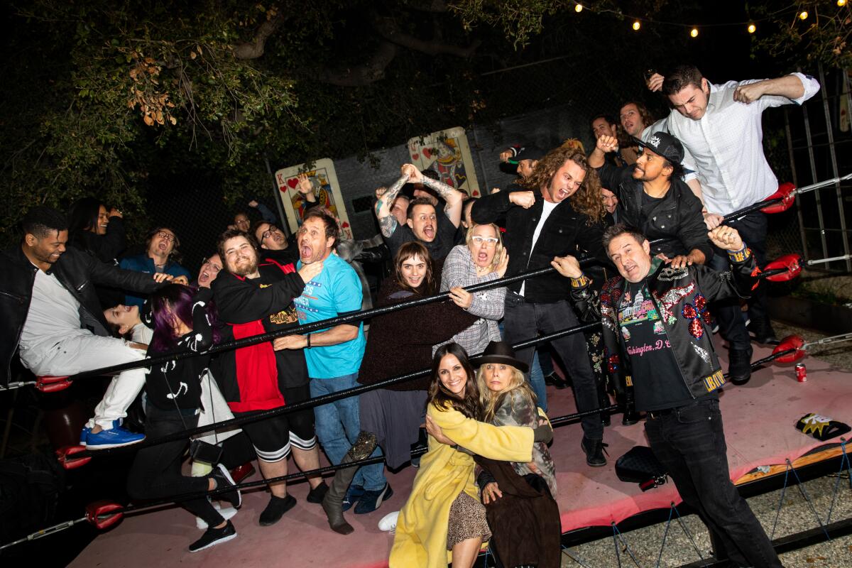 David Arquette with wife Christina McLarty Arquette, hugging Rosanna Arquette, along with family and friends, hold a wrestling pose for a photo in his backyard wrestling ring, after a screening of, "You Cannot Kill David Arquette," at Arquette's Encino, CA, home, March 07, 2020. The documentary following Arquette's foray into professional wrestling, was set to premier at the SXSW festival, but after it was cancelled due to the COVID-19 virus, Arquette's wife Christina McLarty Arquette, an executive producer of the doc, decided to host a screening of the film at their home.