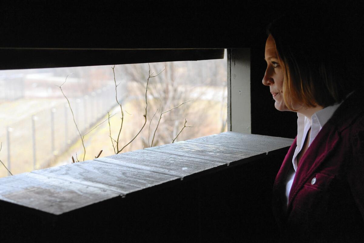 Sarah Converse, an ecologist, observes whooping cranes from a blind at the Patuxent Research Refuge near Laurel, Md.