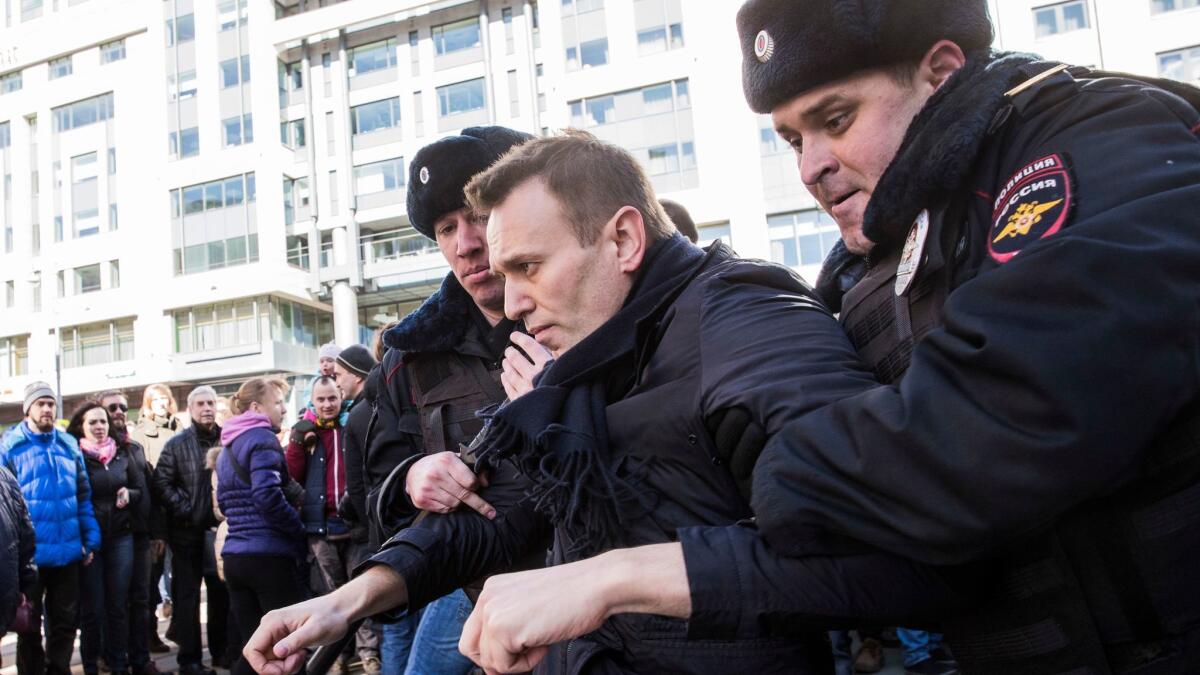 In this photo provided by Evgeny Feldman, Alexei Navalny is detained by police in downtown Moscow on March 26. (Evgeny Feldman / Associated Press)