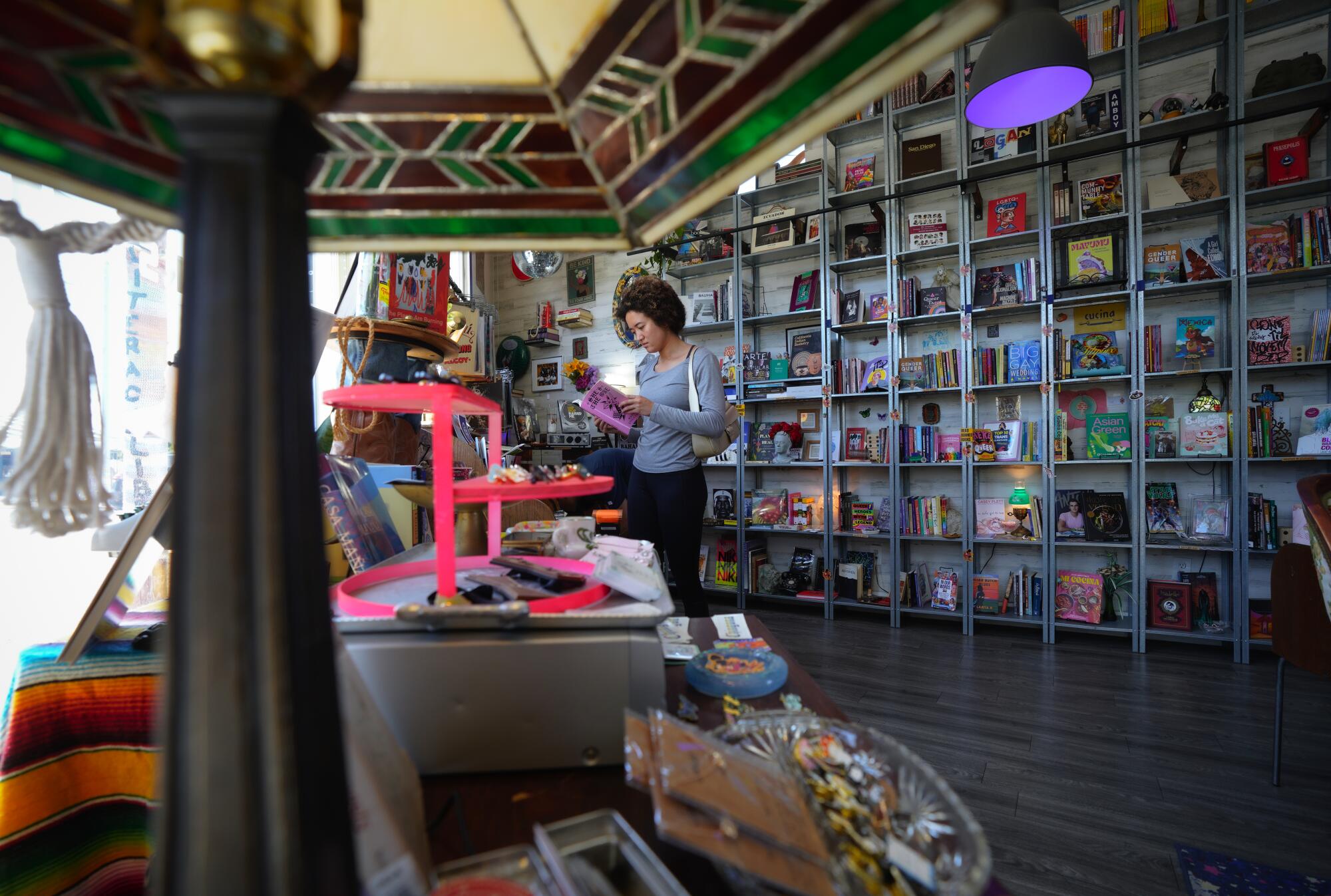 Customers shop at Libélula bookstore, a 700-square-foot space in the Barrio Logan Community in San Diego, CA.