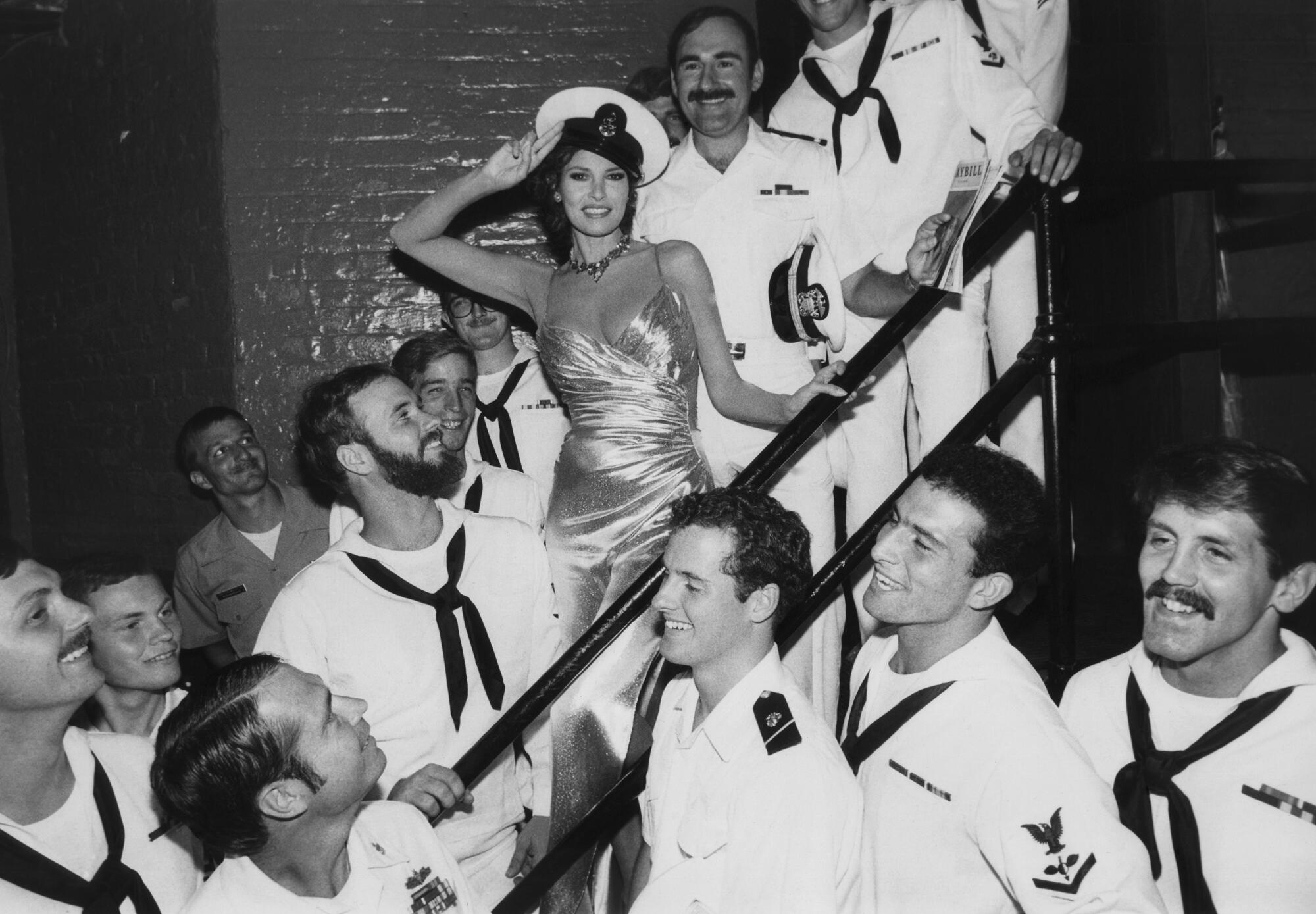 Raquel Welch, starring in Broadway’s ‘Woman of the Year,’ poses with sailors 
