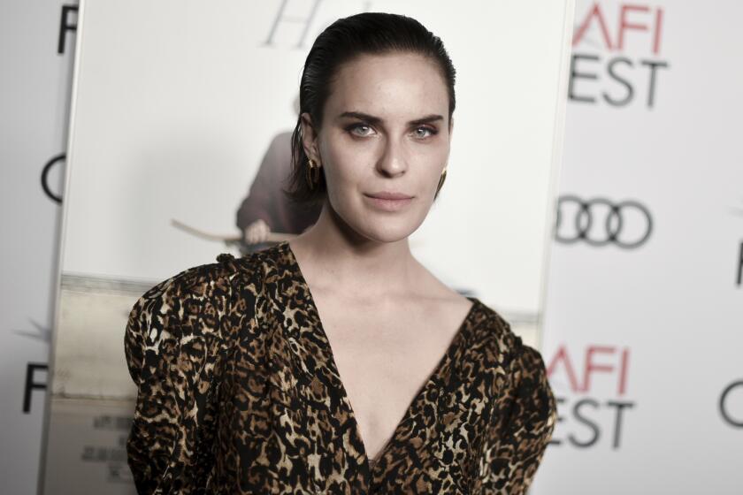 Tallulah Willis poses in a leopard-print outfit with puffy sleeves and a plunging neckline.