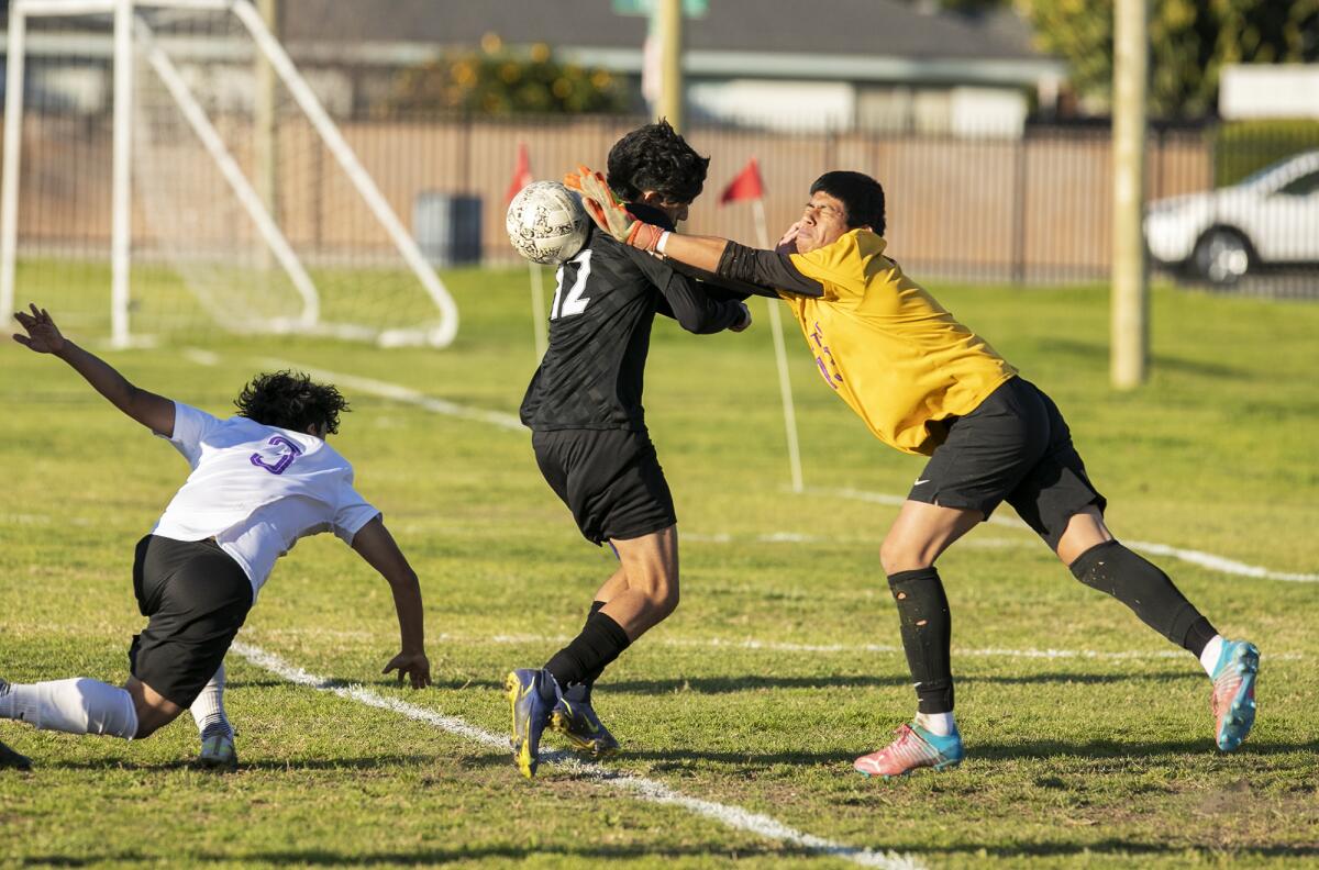 Los Amigos' Oracio Teriquez collides with Santiago goalkeeper Eduardo Estrada, drawing a penalty kick on Tuesday.