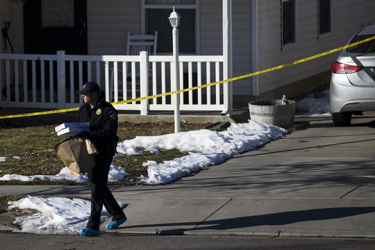 Investigators collect evidence from the home in Spanish Fork, Utah, where Lindon Police Officer Joshua Boren his family were found dead Thursday night.