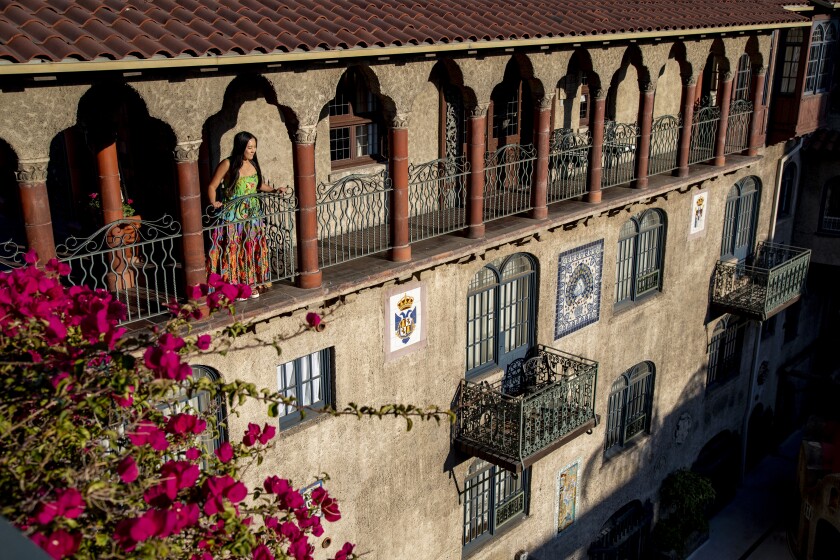 A woman takes in the view overlooking the Spanish patio at the Mission Inn.