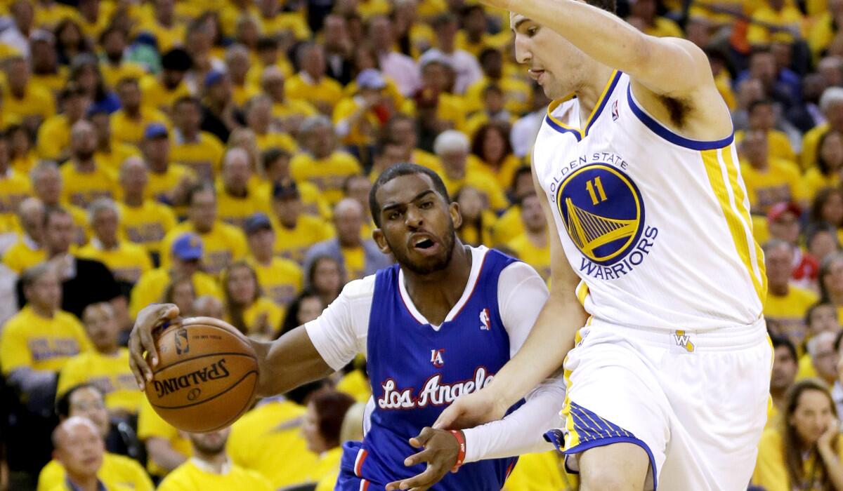 Clippers point guard Chris Paul tries to drive past Warriors guard Klay Thompson in the first half.