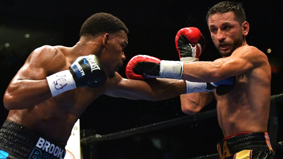 Daniel Jacobs lands a left jab to the chest of Sergio Mora during their fight Friday.