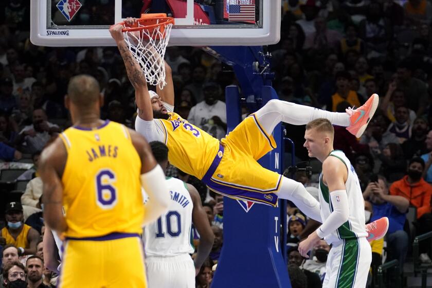 Los Angeles Lakers forward Anthony Davis (3) dunks over Dallas Mavericks' Dorian Finney-Smit.