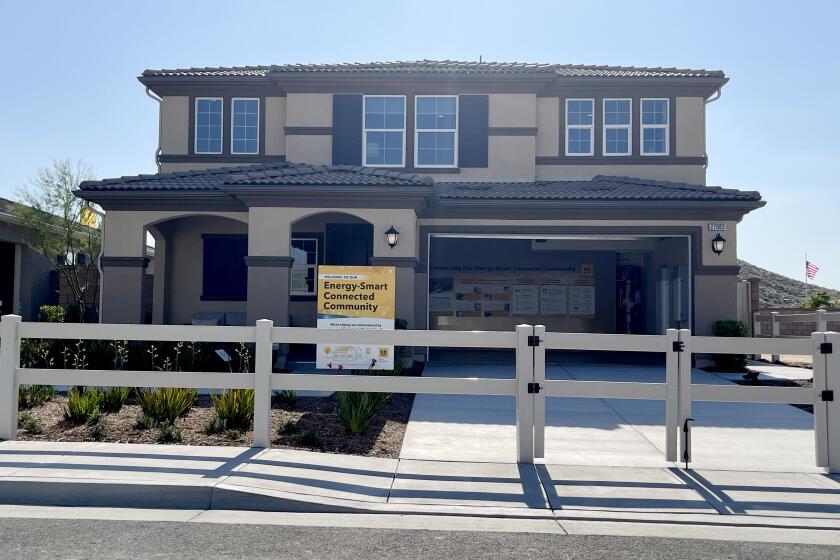 A model home is one of 219 units in two adjacent subdivisions in the Inland Empire city where homes come equipped with rooftop solar panels, on-site battery storage and smart electrical panels that manage home energy use. The homes in the Durango and Oak Shade at Shadow Mountain subdivisions will also be connected to community battery storage as part of a U.S. Department of Energy-funded microgrid project that will also help them keep the lights on during a power outage. (Tony Barboza/Los Angeles Times)