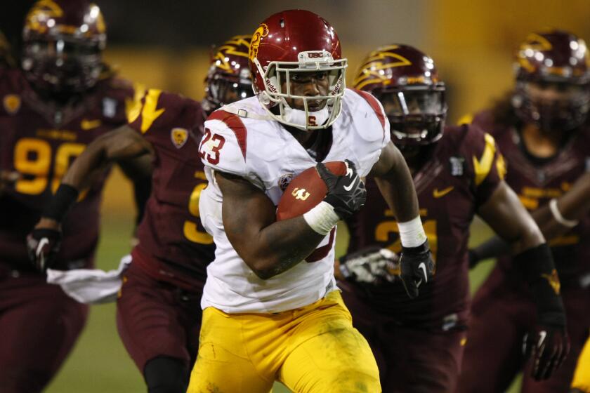 Southern California running back Tre Madden (23) scores a touchdown against Arizona State during the second half of an NCAA college football game on Saturday, Sept. 28 2013, in Tempe, Ariz. (AP Photo/Rick Scuteri)