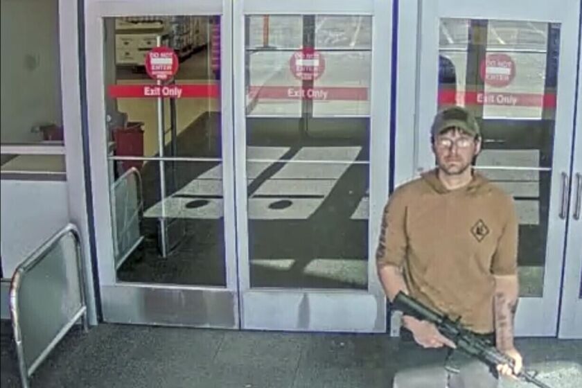 FILE - In this image taken from security camera footage provided by the Omaha, Neb., Police Department, a man identified by police as Joseph Jones, armed with an AR-15-style rifle, is seen at a Target store in Omaha on Jan. 31, 2023, before police fatally shot him. Jones, who entered the Omaha Target with an AR-15-style rifle and began firing before he was killed by police had been repeatedly sent to psychiatric hospitals because of his schizophrenia. But because Jones was never formally committed, he was able to keep purchasing guns legally, underscoring how little so-called red-flag laws do to keep firearms away from deeply troubled people. (Omaha Police Department via AP, File)