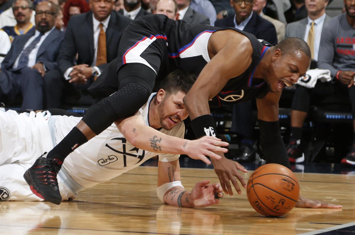 Clippers forward Paul Pierce, top, vies for control of a loose ball with Denver guard Mike Miller on Tuesday night.