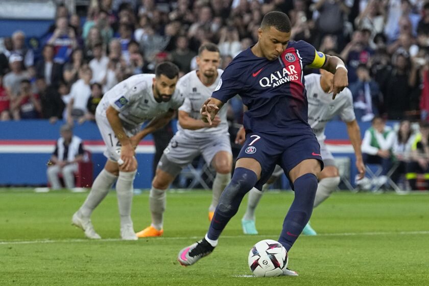 PSG's Kylian Mbappe scores his side's second goal from a penalty kick during the French League One soccer match between Paris Saint-Germain and Clermont at the Parc des Princes in Paris, France, Saturday, June 3, 2023. (AP Photo/Michel Euler)