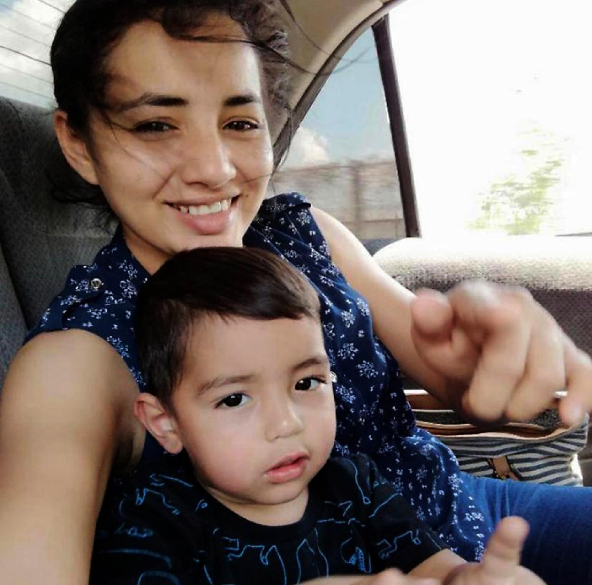 Karen Cruz Caceres with her son in a car.