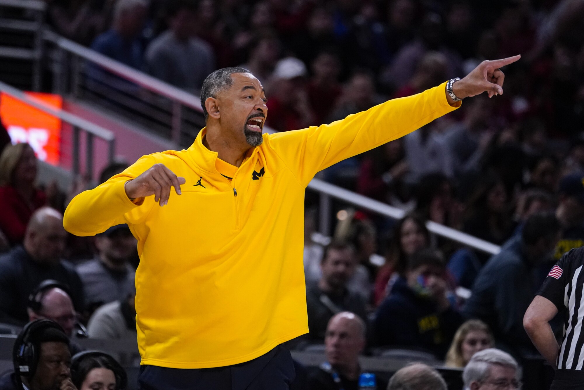 Michigan basketball coach Juwan Howard points out how he directs his players on the court.