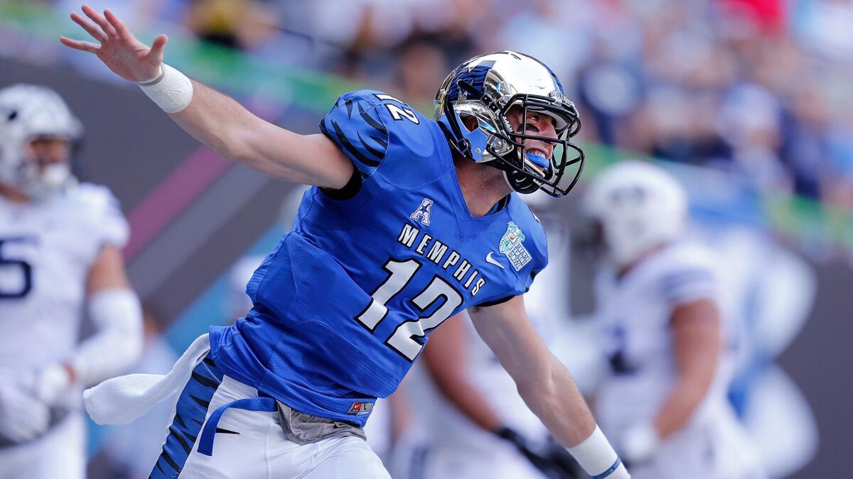 Memphis quarterback Paxton Lynch celebrates after throwing a touchdown pass during the first quarter of a 55-48 double-overtime win against Brigham Young in the Miami Beach Bowl on Monday.