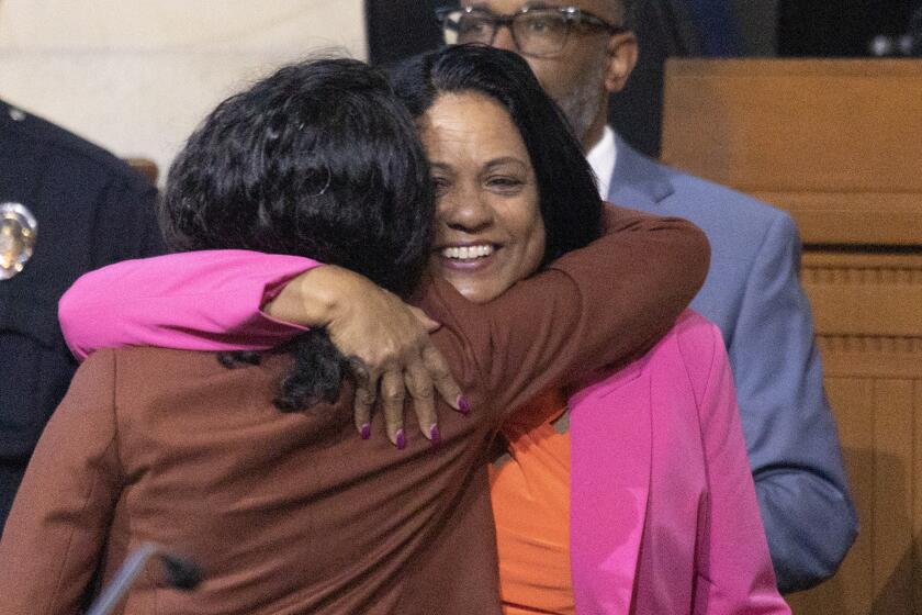 Los Angeles, CA - April 11: Heather Hutt, right, who was previously appointed caretaker of the 10th District, is congratulated by Nithya Raman Councilmember District 4, after being voted in to the Los Angeles City Council's 10th District seat to fill out the term of former Councilman Mark Ridley-Thomas, who was found guilty of federal corruption charges, at City Hall in Los Angeles Tuesday, April 11, 2023. (Allen J. Schaben / Los Angeles Times)