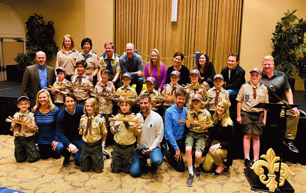 Arrow of Light award recipients from La Jolla's Pack 4 Cub Scouts get promoted to Boy Scouts and celebrate with their parents.