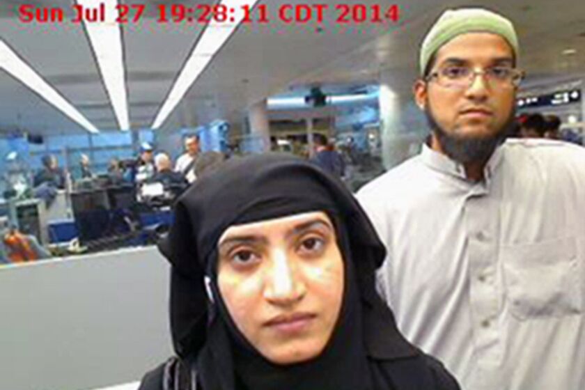 A photo from July 27, 2014, provided by the U.S. Customs and Border Protection agency shows Tashfeen Malik, left, and Syed Rizwan Farook as they passed through O'Hare International Airport in Chicago.