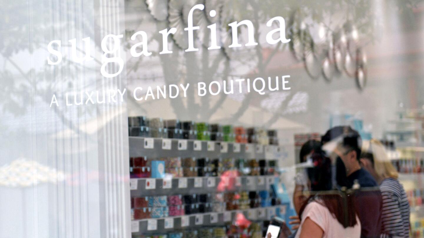 Customers peruse the sweet stuff at Sugarfina luxury candy boutique at the Americana at Brand shopping center in Glendale.