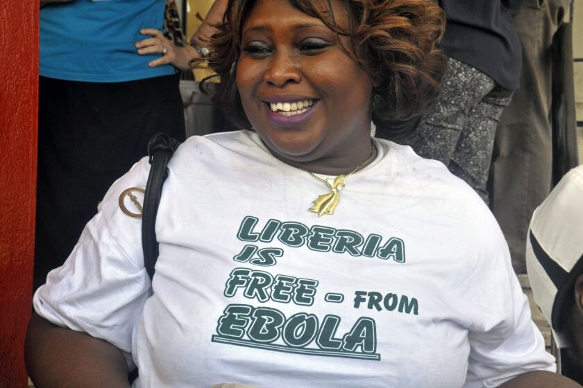 A woman celebrates Liberia being declared Ebola free in Monrovia, Liberia, on Saturday.