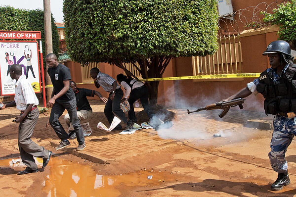 Ugandan police in Kampala on Tuesday use tear gas to disperse protesting journalists outside the Daily Monitor and Red Pepper newspapers, which were closed May 20 by police.