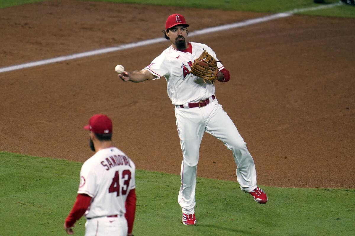 Angels third baseman Anthony Rendon makes an off-balance throw to put out the Diamondbacks' Nick Ahmed at first base.