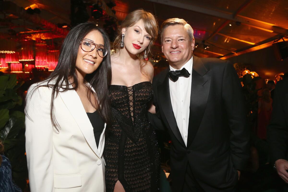 Taylor Swift, center, with Netflix executives Lisa Nishimura and Ted Sarandos at the Netflix 2019 Golden Globes after-party.
