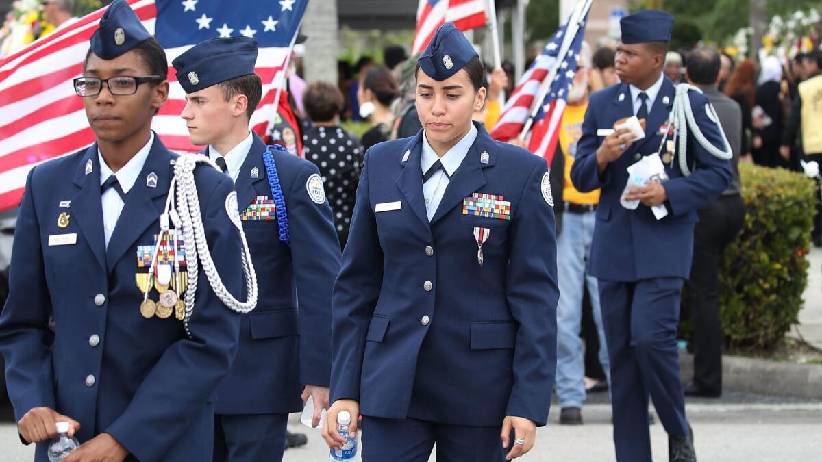 Mourners leave the funeral of Peter Wang, 15, who was a JROTC cadet, at Kraeer Funeral home on Feb. 20 in Coral Springs, Fla. Wang was killed in the mass shooting at Marjory Stoneman Douglas High School along with 16 other people.