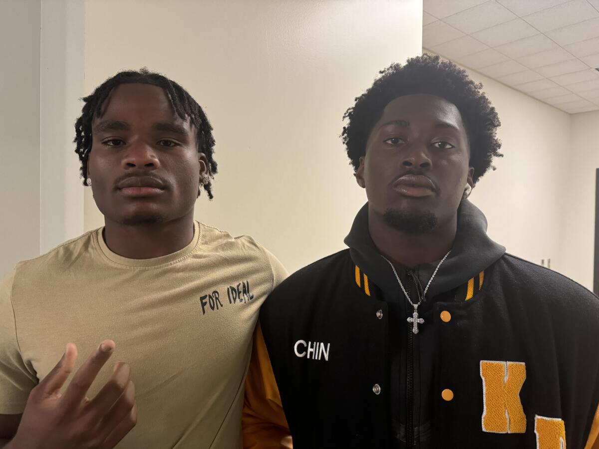 Narbonne linebacker Mark Iheanachor (left) and King/Drew defensive end Chinedu Onyeagoro pose for a photo.