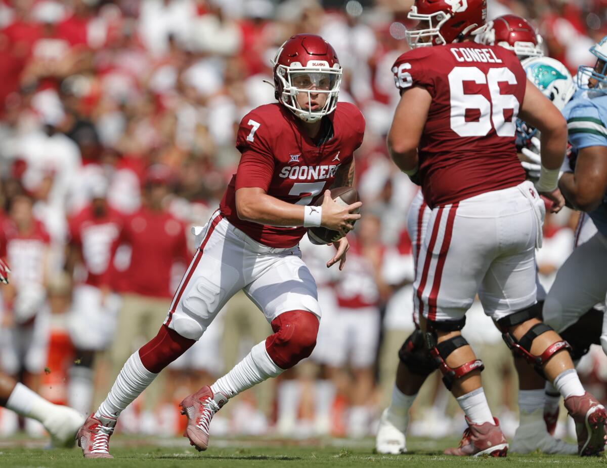 Oklahoma quarterback Spencer Rattler (7) scrambles to find an opening on a play against Tulane during a NCAA college football game Saturday, Sept. 4, 2021, in Norman, Okla. (AP Photo/Alonzo Adams)