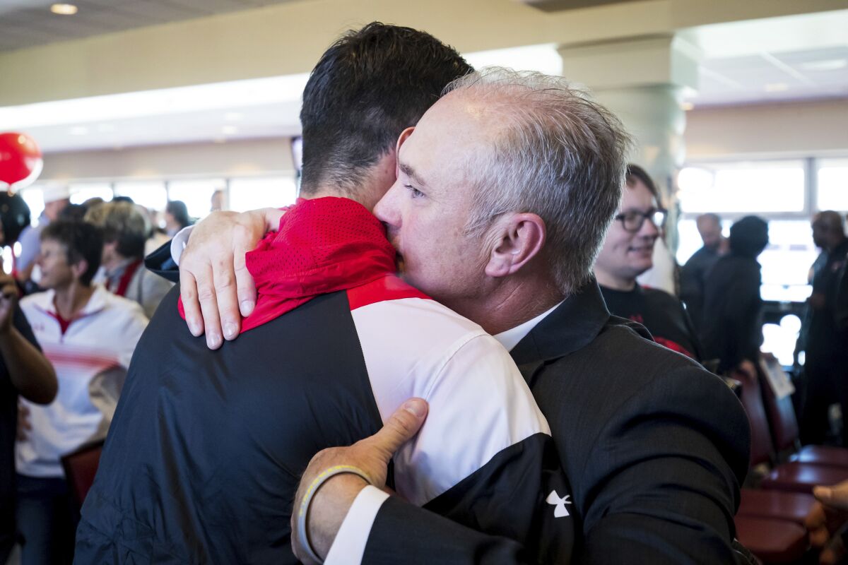 New Texas Tech head football coach Joey McGuire greets quarterback Behren Morton after an NCAA college football news conference, Tuesday, Nov. 9, 2021, at Jones AT&T Stadium in Lubbock, Texas. (John Moore/Lubbock Avalanche-Journal via AP)