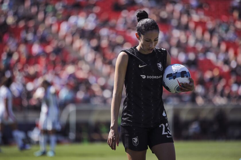 FULLERTON, CALIFORNIA - MARCH 26: Christen Press #23 of Angel City FC carries the ball over for a corner kick in the second half against the OL Reign at Titan Stadium on March 26, 2022 in Fullerton, California. (Photo by Meg Oliphant/Getty Images)