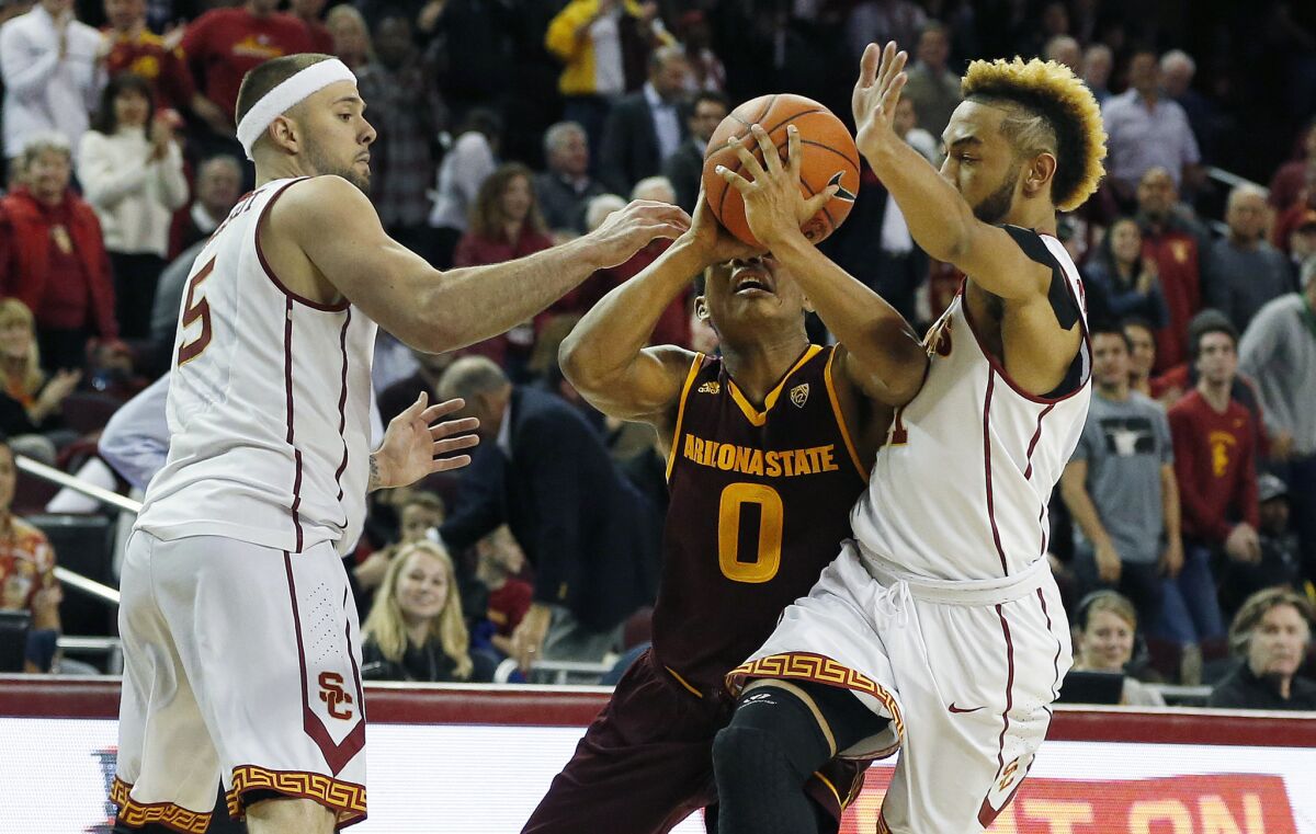 USC guards Katin Reinhardt, left, and Jordan McLaughlin right, double team Arizona State guard Tra Holder during a game on Jan. 7