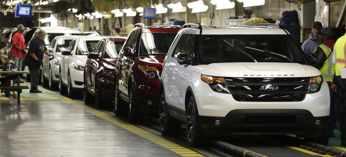 Workers inspect 2015 Ford Explorer, right, as it rolls off the assembly line at the Chicago Ford Assembly Plant in Chicago. Ford plans big changes for the 2016 model.