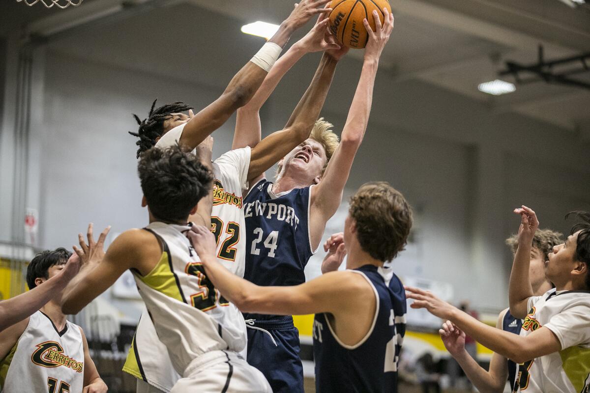 Newport Harbor's Adam Gaa, goes up for a rebound against Cerritos' Osinachi Agaranna during a playoff game on Friday