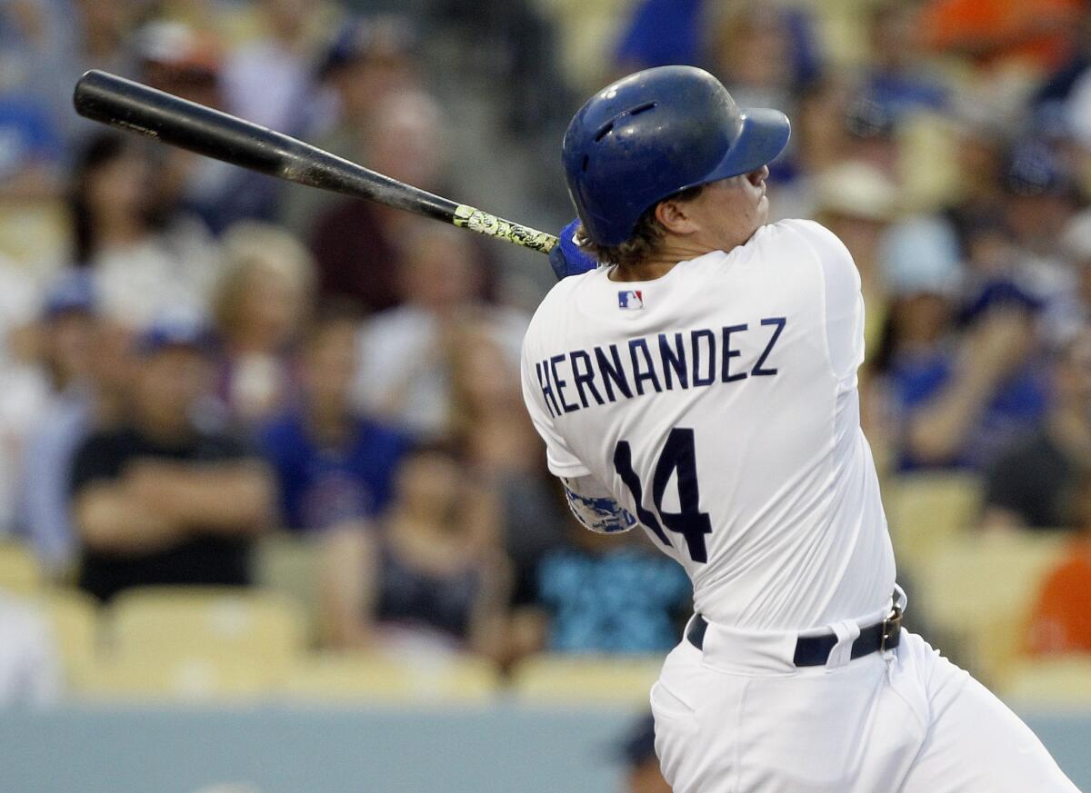 Enrique Hernandez hits an infield single to score Jose Peraza during the third inning of a game gainst the Chicago Cubs on Aug. 29. The Dodgers beat the Cubs, 5-2.