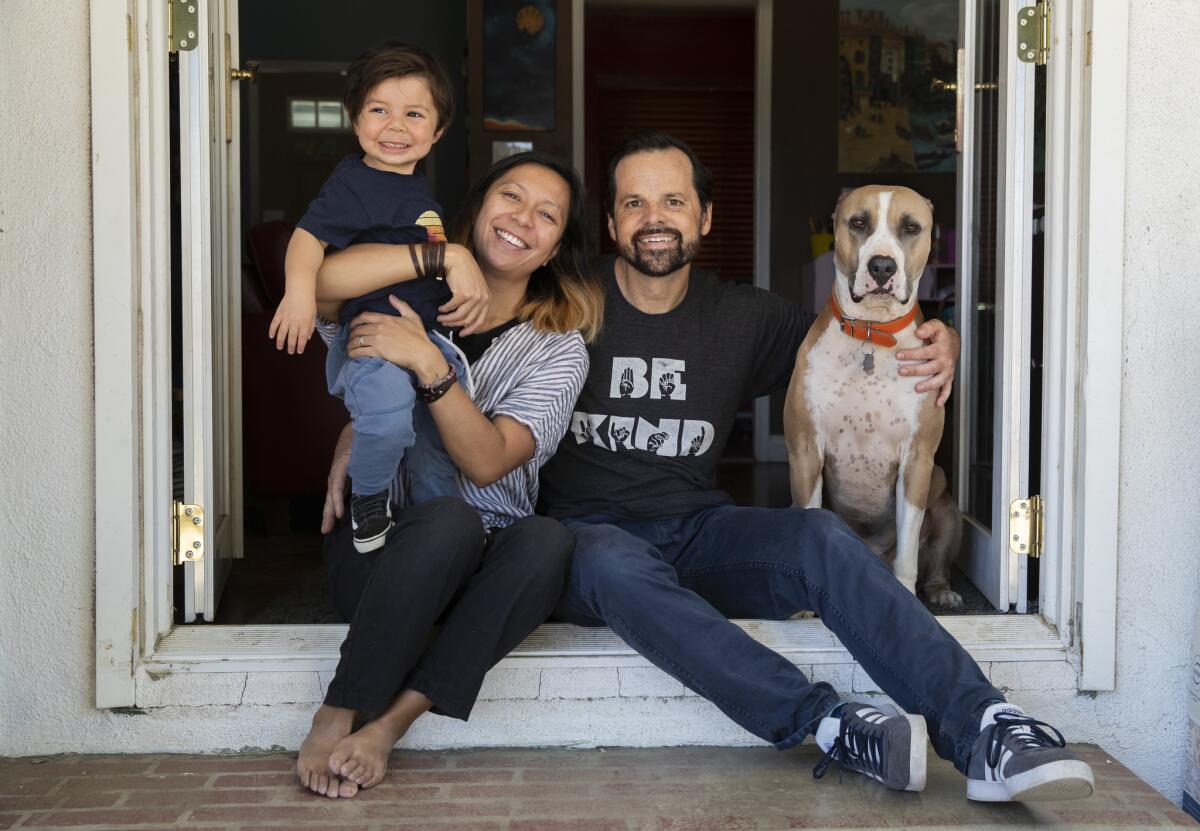 Kidney donor Keith Michaelis with his wife, Cecile, son Henry, 2, and dog Finn, a 5-year-old Staffordshire-Great Dane, at their home in Winnetka.
