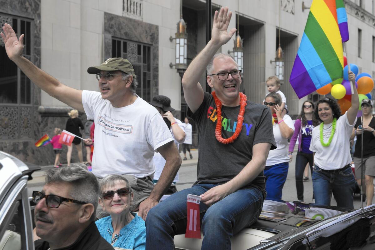 James Obergefell, right, a plaintiff in the Supreme Court case on same-sex marriage, takes part in a gay pride parade in Cincinnati on Saturday. The high court ruled 5 to 4 the day before that same-sex couples had the right to marry nationwide.