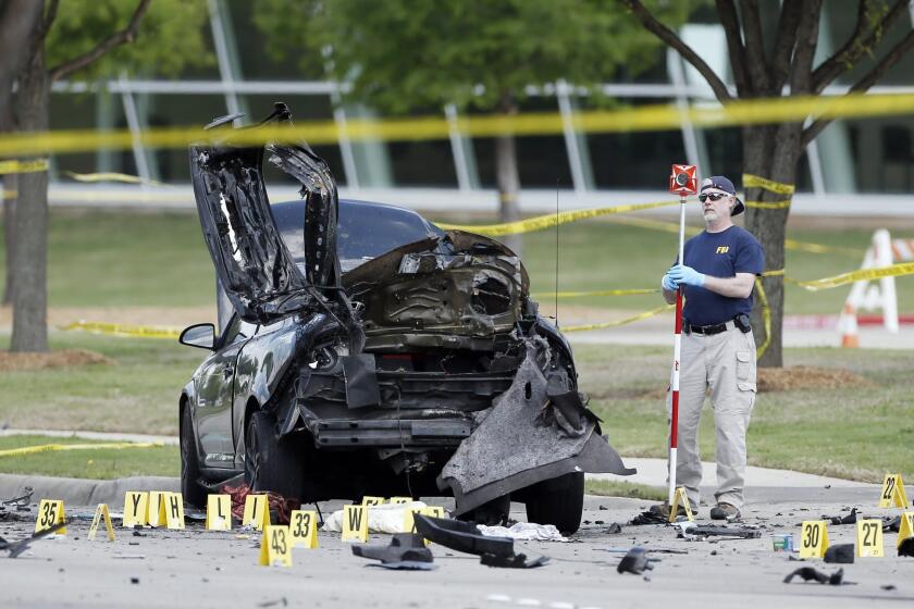 FBI crime scene investigators document evidence outside the Curtis Culwell Center on Monday in Garland, Texas. Two men on Sunday night opened fire with assault weapons outside the building, the site of a contest for Muslim Prophet Muhammed cartoons.